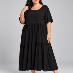 Detalle del cuerpo y la falda por niveles del vestido negro Colección Argentina.